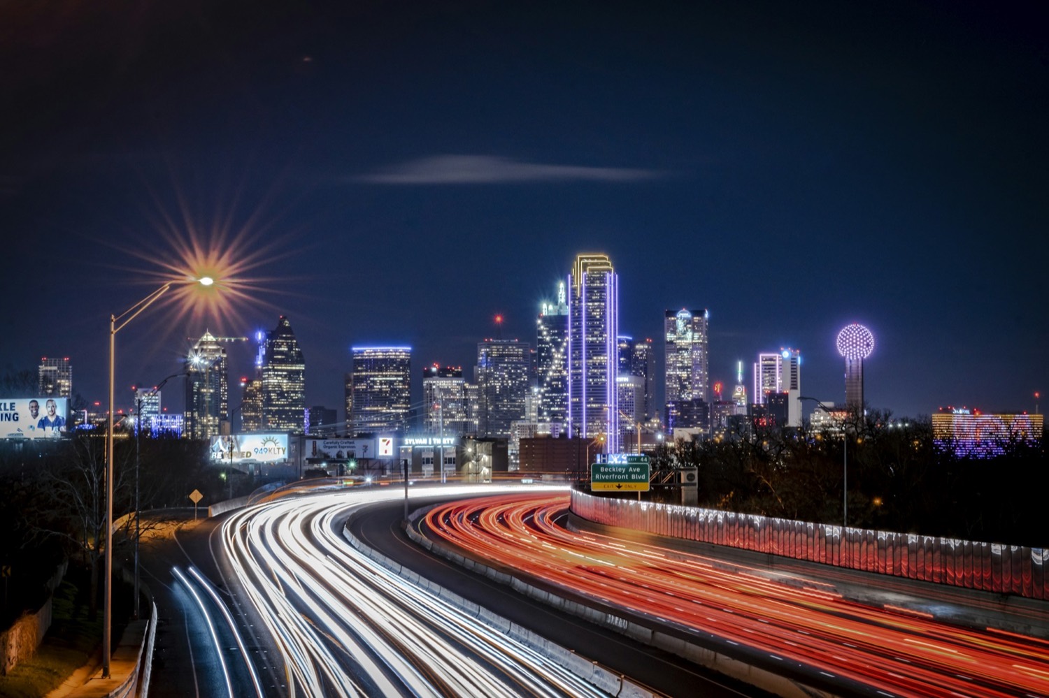 Dallas skyline and highway light trails at night